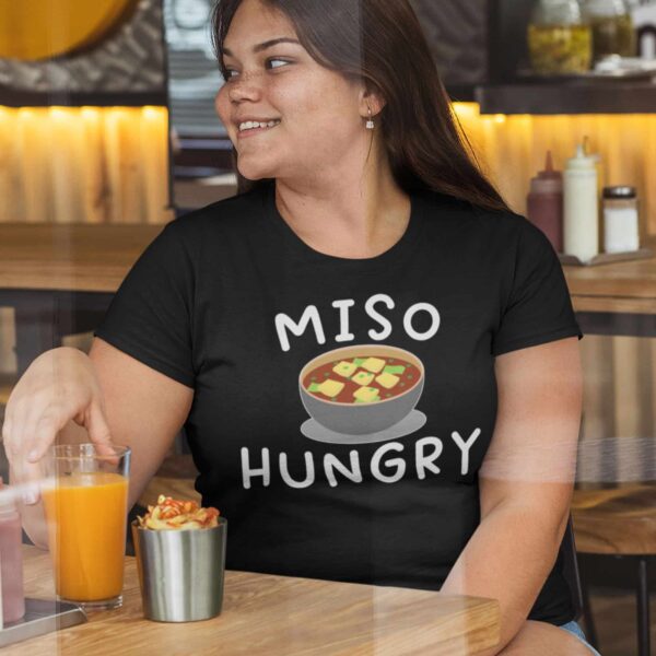 woman wearing a black Miso Hungry funny Miso soup t-shirt